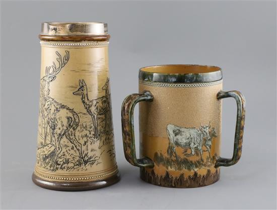 Barlow family. A Doulton Lambeth three handled stoneware tyg and a similar jug, H. 16.5 and 23.5cm, jug handle re-stuck (2)